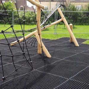 EcoSmart grass mats under wooden playground equipment