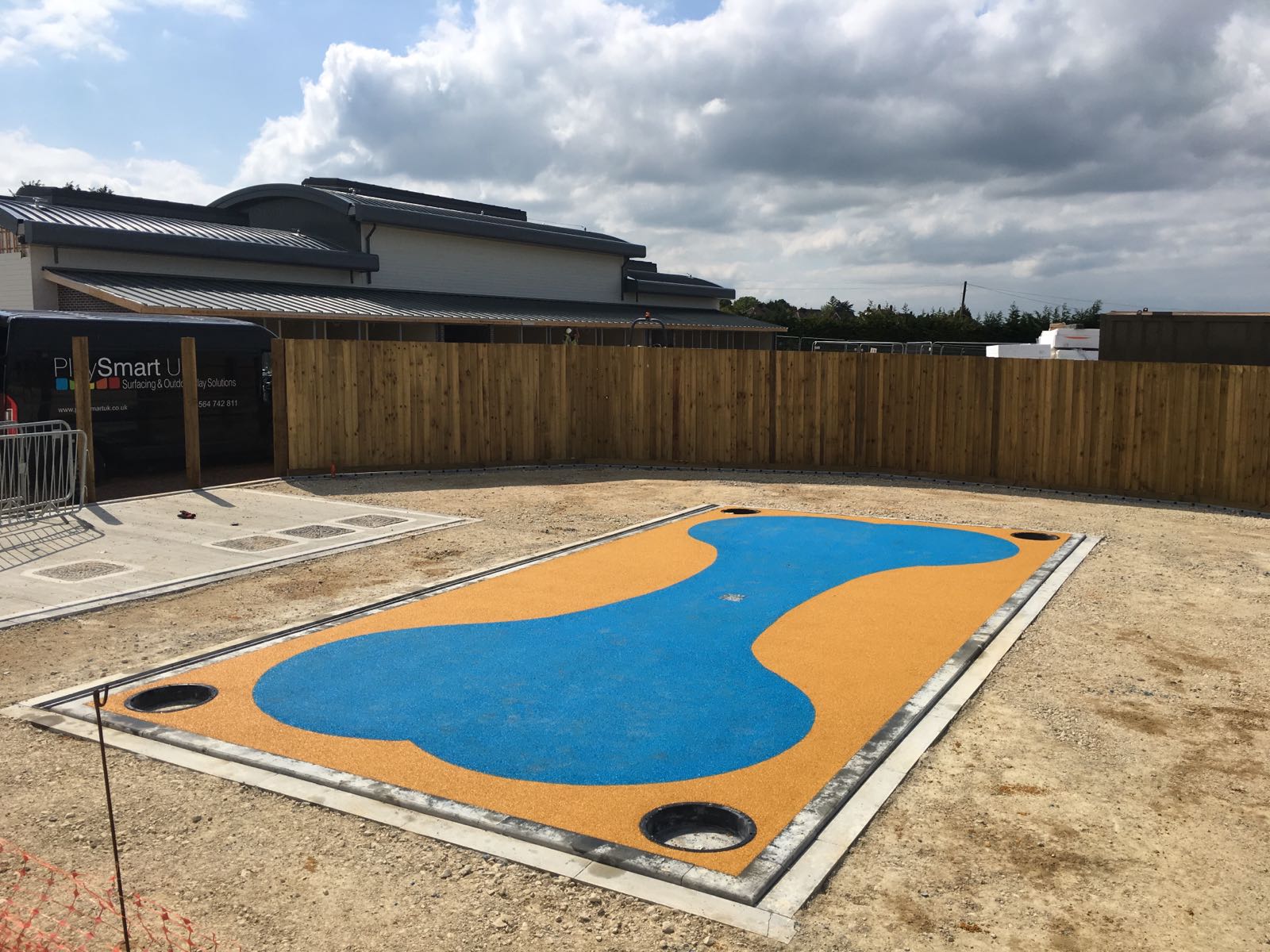 Yllow and blue Safety Surfacing Poured Design with wetpour rubber in the shape of a large bone