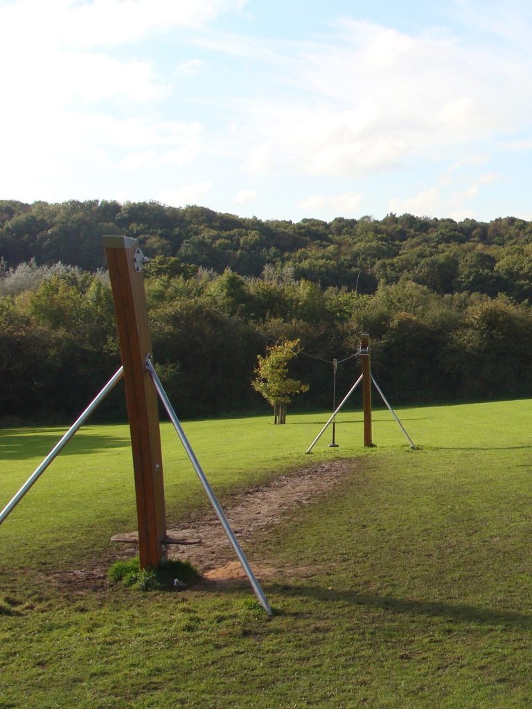 Worn ground underneath playground zip line before EcoSmart installation