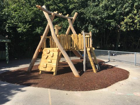 Red Jungle Mulch underneath wooden play tower