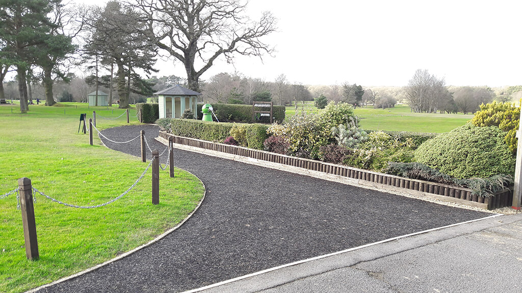 wide grey rubber mulch pathway on golf course