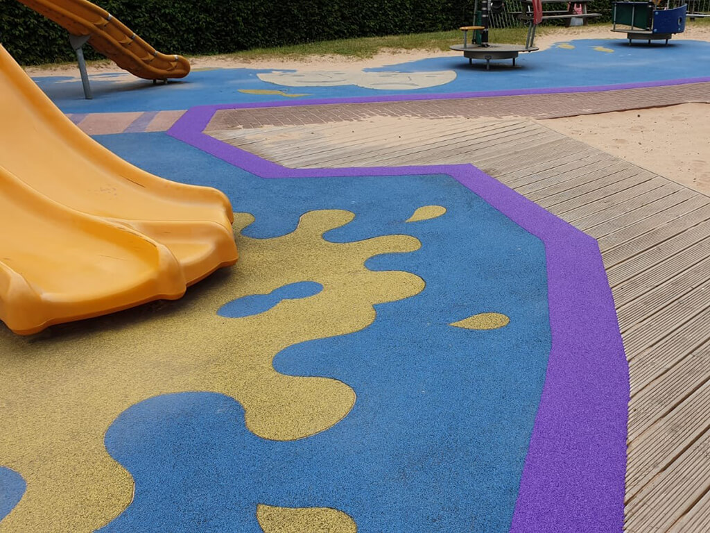 Rubber surface with purple EPDM rubber band around the edges and yellow EPDM wear pad at the base of a slide