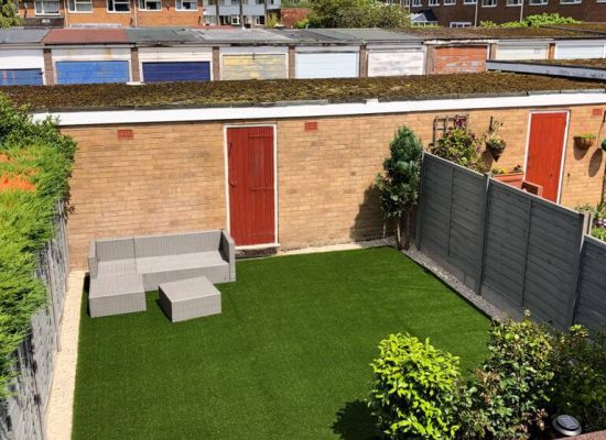 Square of Green Frog Artificial Grass installed in a small walled garden