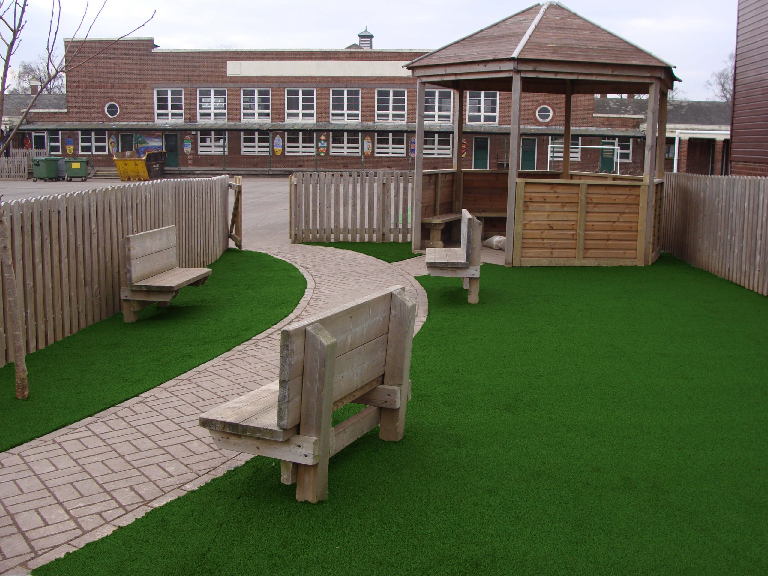 Artifiical Grass in a school garden alongside decorative path