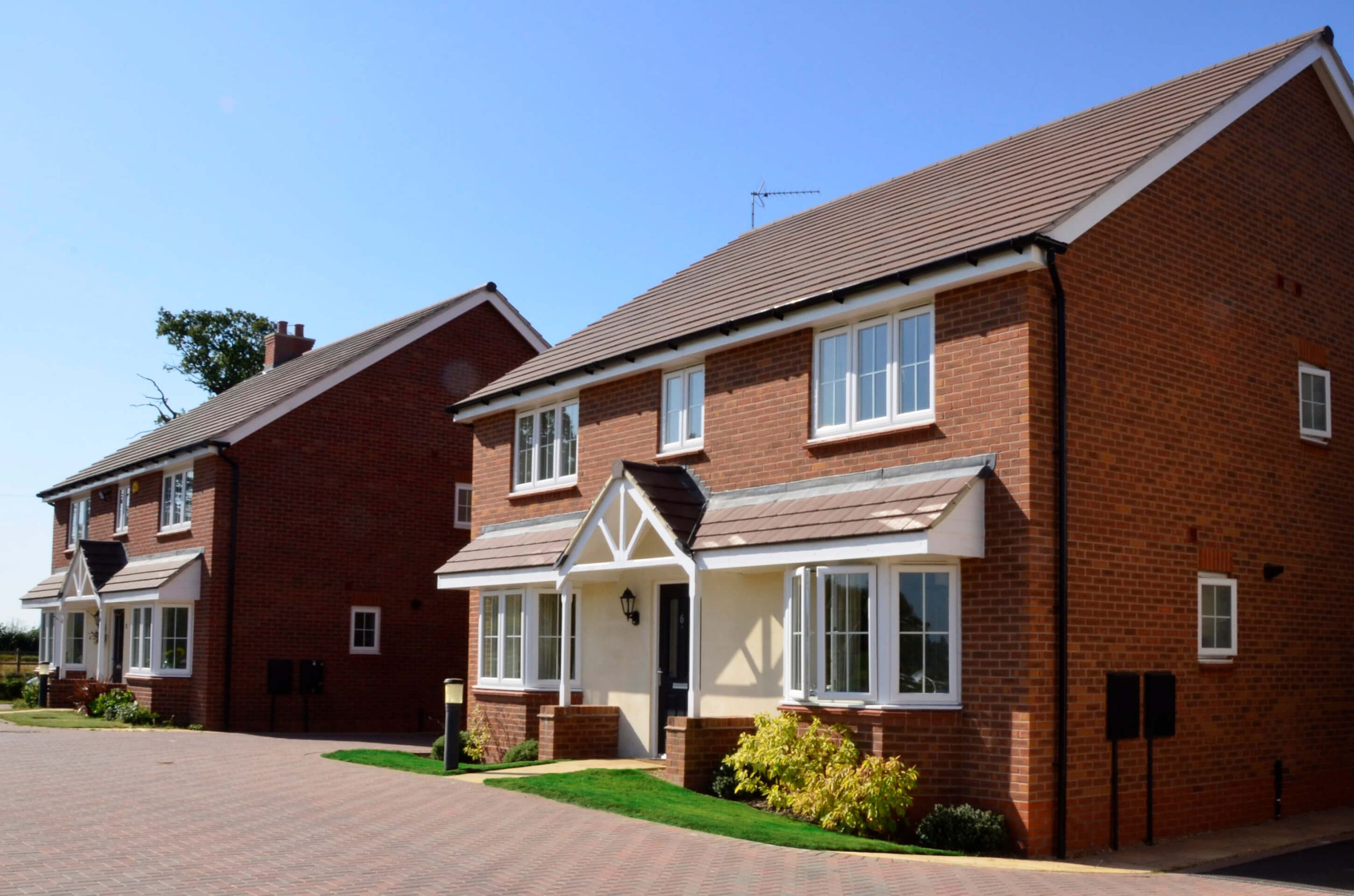 Residential housing with small artificial grass lawn
