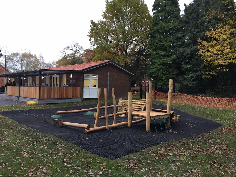 EcoSmart grass mats installed as safety surfacing underneath school playground equipment