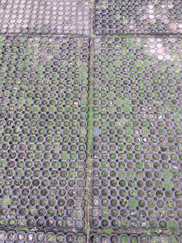 Poorly installed grass mats coming apart
