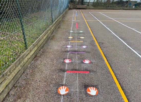 Colourful hand and line markings on a Daily Mile track