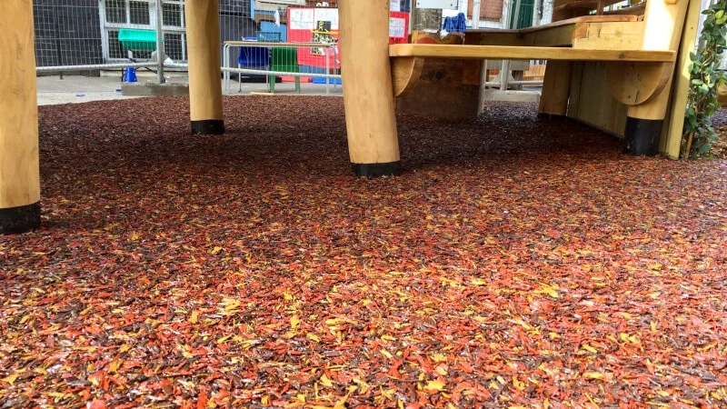 PlaySmart’s Jungle Mulch bonded rubber mulch outdoor play surfacing solution in Autumnal shades of red, yellow, orange and brown.