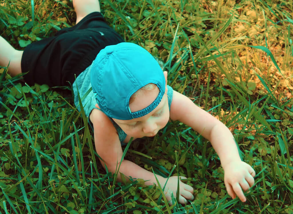 child playing on synthetic grass
