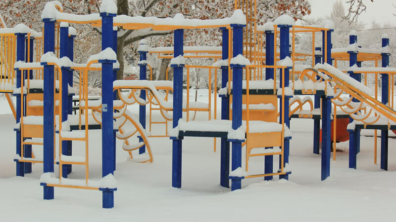 Climbing frame playground covered in snow