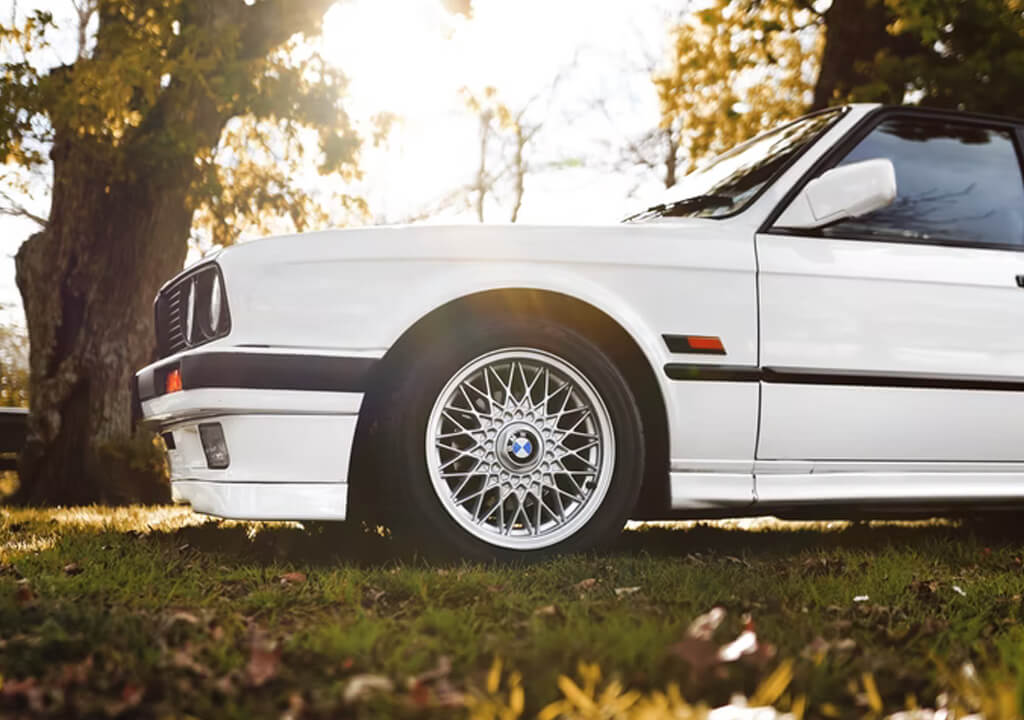 white car parked on an artificial grass surface