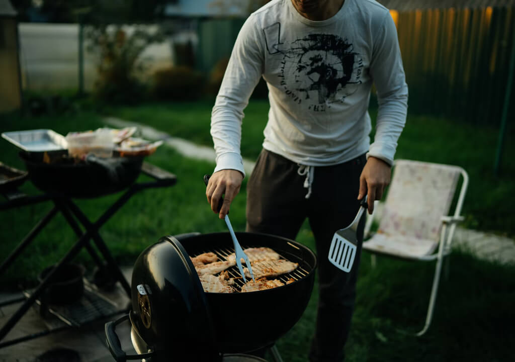 Man grilling meat on a Barbecue