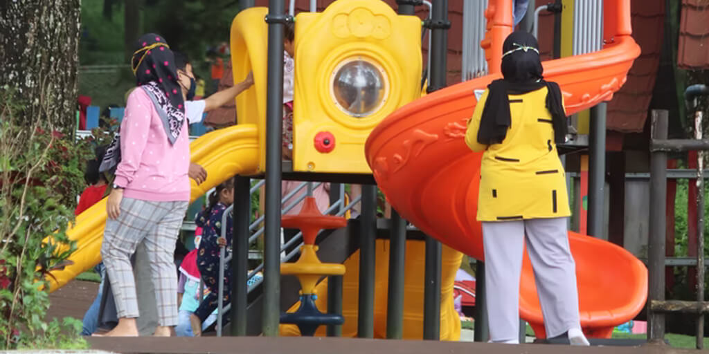 children playing around a play tower