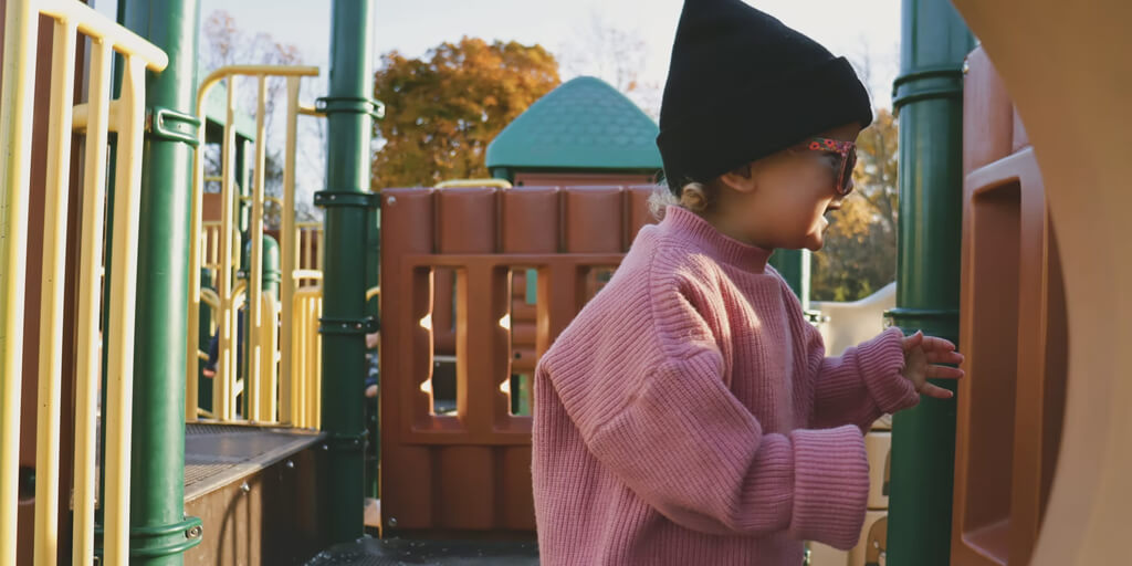 child looking out of play tower