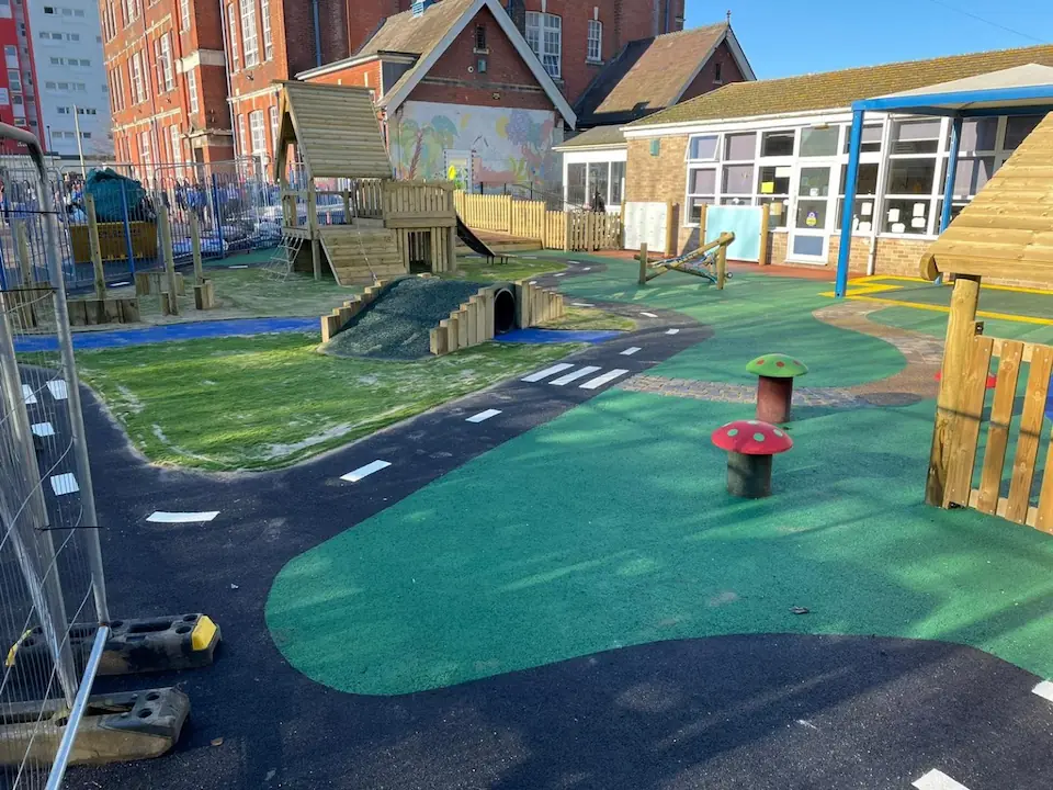 Wetpour playground design with roadway and green surfaces