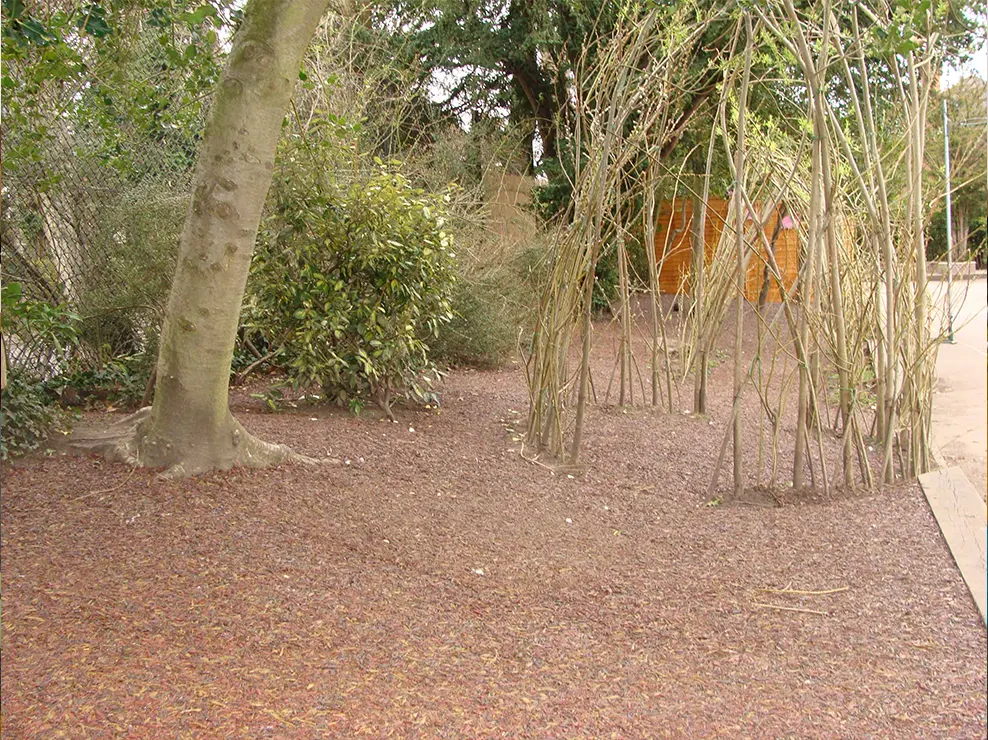 Red/Brown JungleMulch installed alongside a pathway as a tree surround