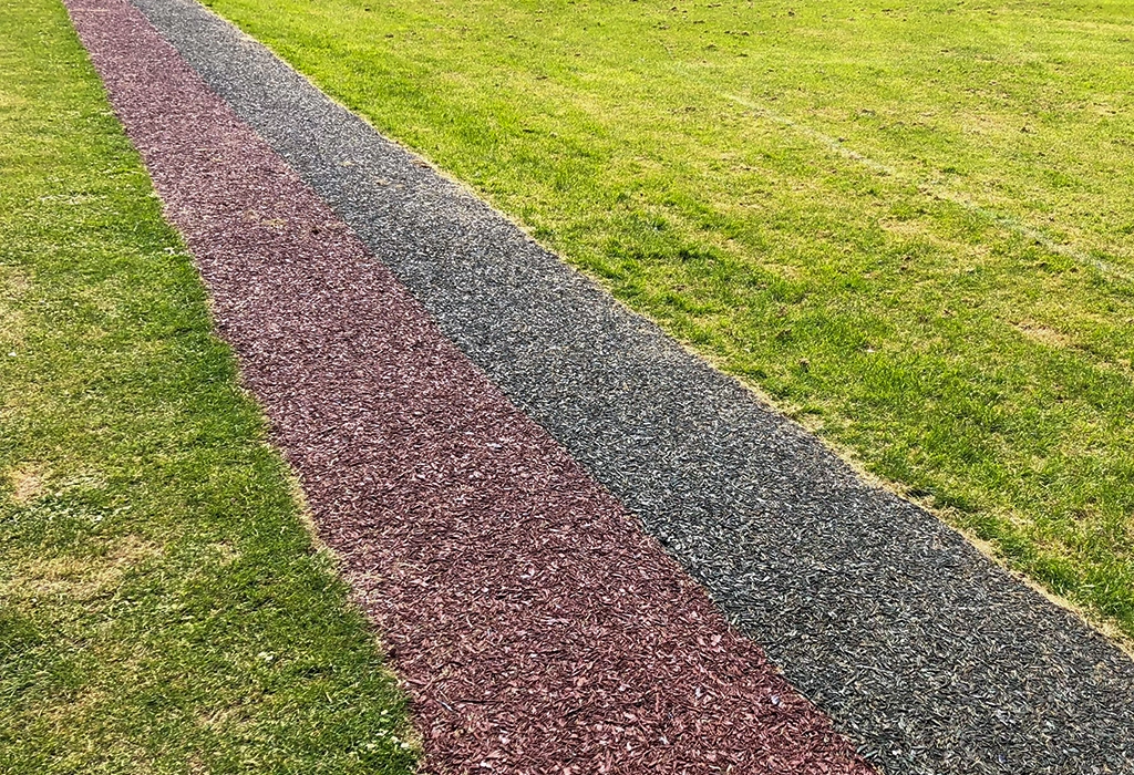 Boothwood Primary Red and Black Rubber Mulch Running Track Installation