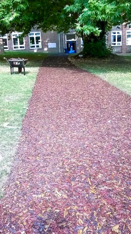 Red rubber mulch pathway at Wycombe Abbey