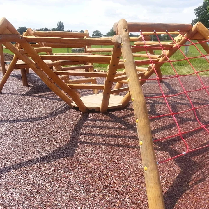 Rustic Red Rubber Mulch installed under equipment in a local village play area