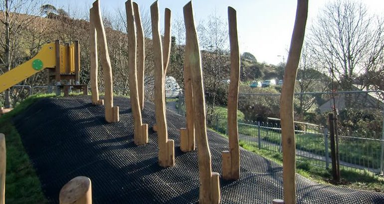 Rubber grass mat surfacing on a hill around obstacle course