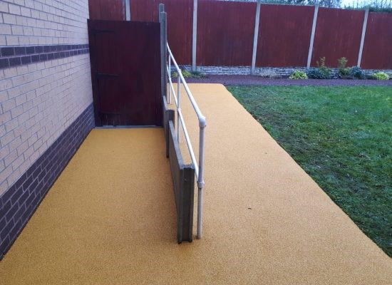 Yellow Rubber Mulch surface on accessibility ramp