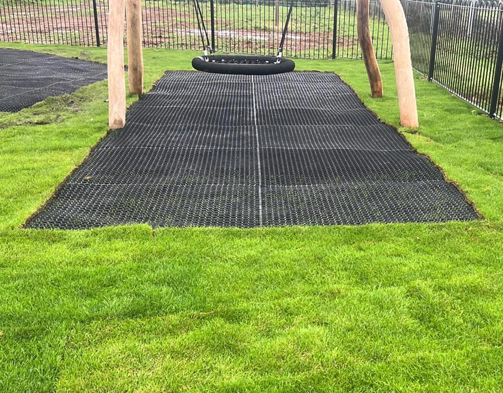 visible grass mat under wooden playground equipment