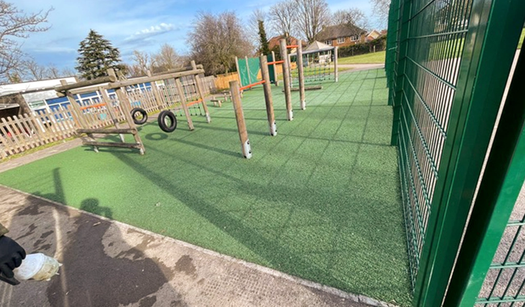 Green EPDM Rubber play area under wooden trim trail equipment
