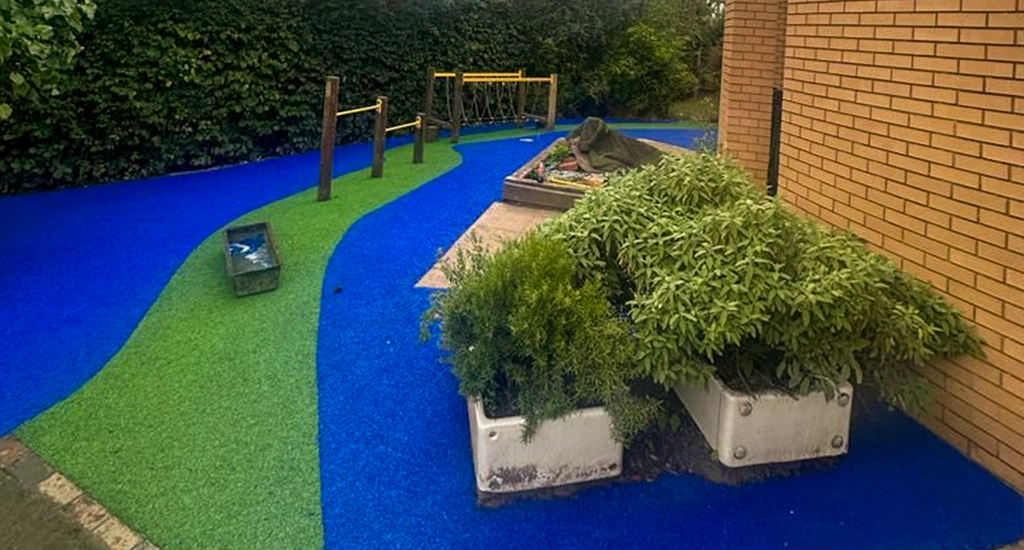 Vibrant green and blue EPDM rubber walkway under playground equipment