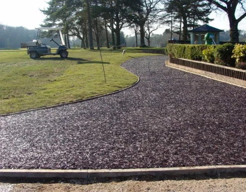 Golf course with golf buggy and rubber mulch pathway