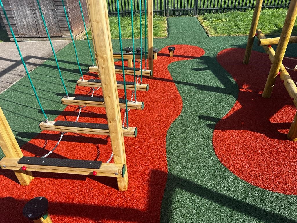 EPDM Mulch installed in creative red and green design at St. Louis Playground