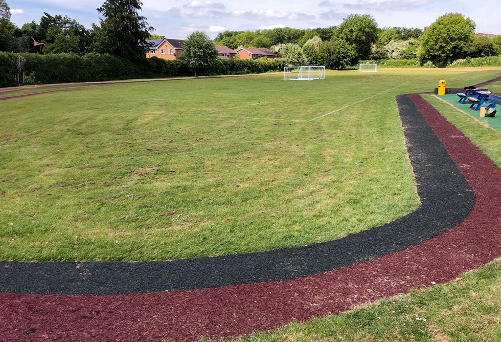 Boothwood Primary Red and Black Rubber Mulch Running Track Installation