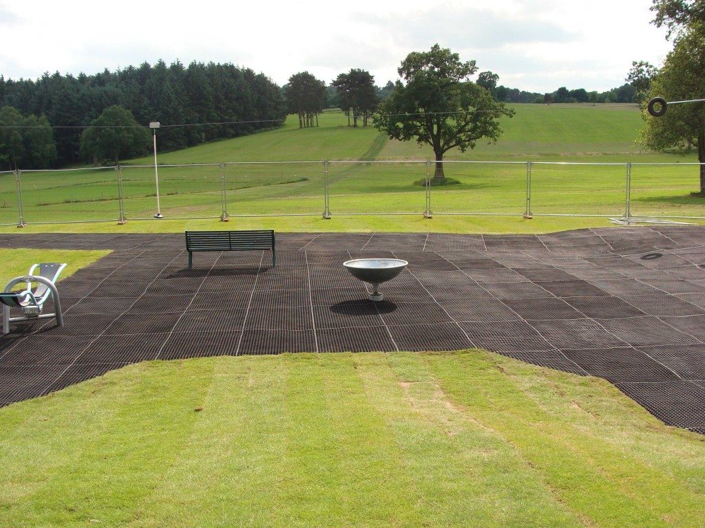 Large area of grass mats installed in an open park playground area