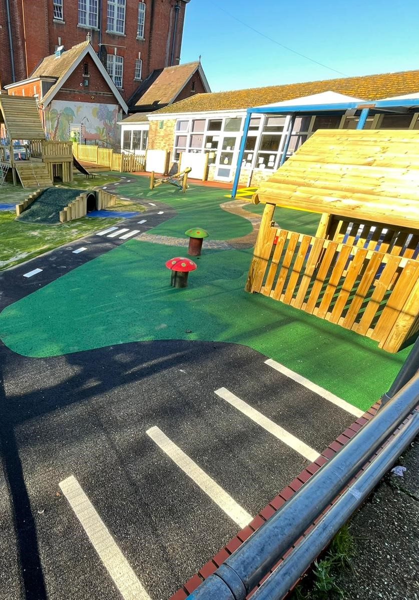 Wetpour playground design with roadway and green surfaces