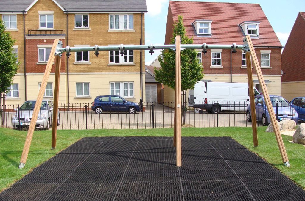 Rubber grass amt square underneath a residential swing set