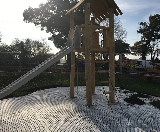 SmartPlay safety surfacing installation on a playground before final grass mats, soil, and grass growth