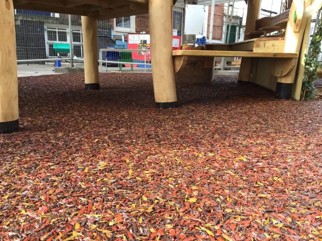 PlaySmart’s Jungle Mulch bonded rubber mulch outdoor play surfacing solution in Autumnal shades of red, yellow, orange and brown.