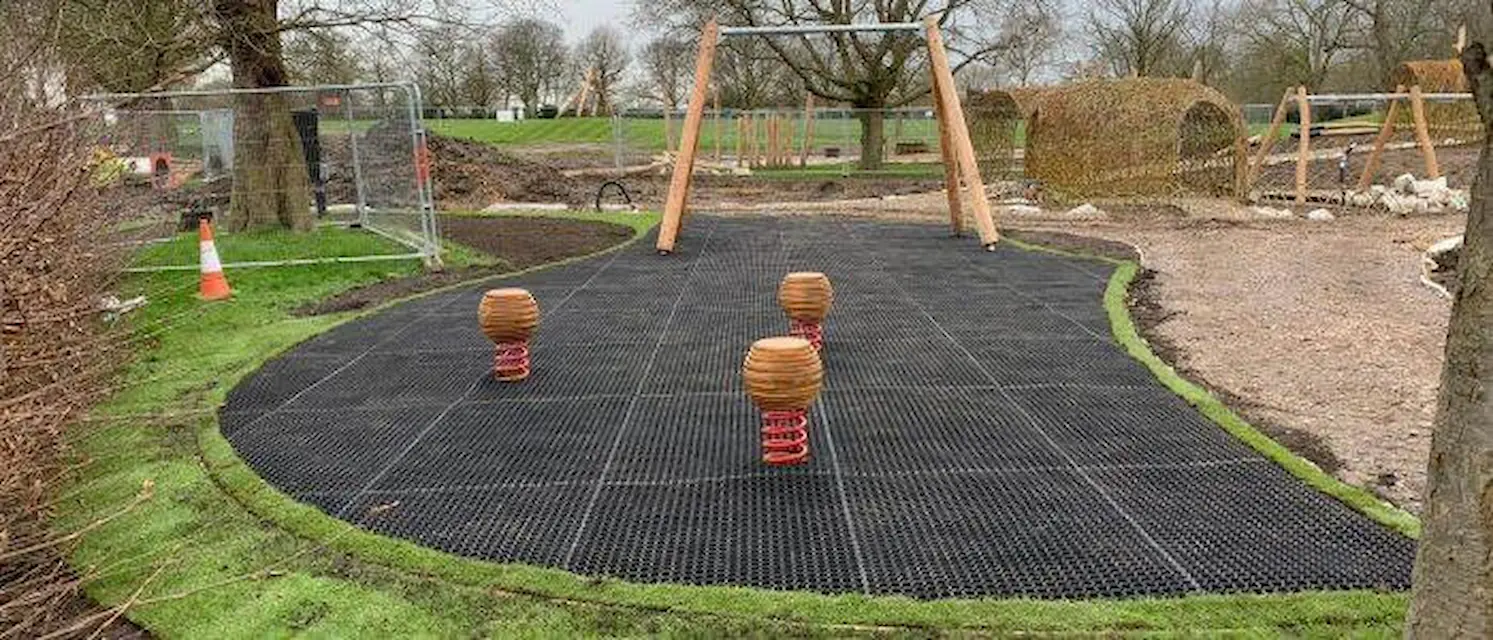Rubber grass mats underneath playground equipment