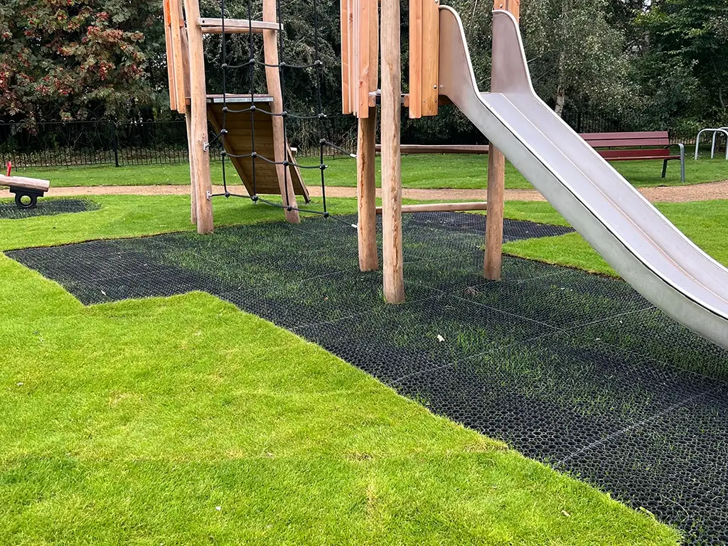EcoSmart under slide multiplay equipment in a park with partial grass growth