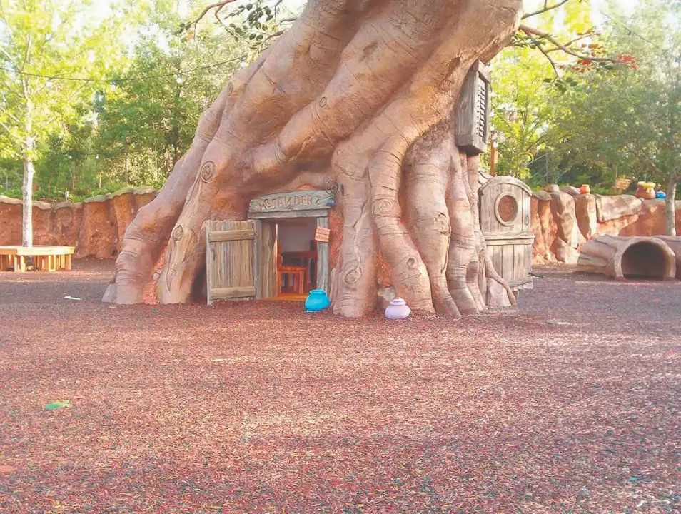 Rainbow JungleMulch surrounding a life sized version of Winnie the Pooh's treehouse
