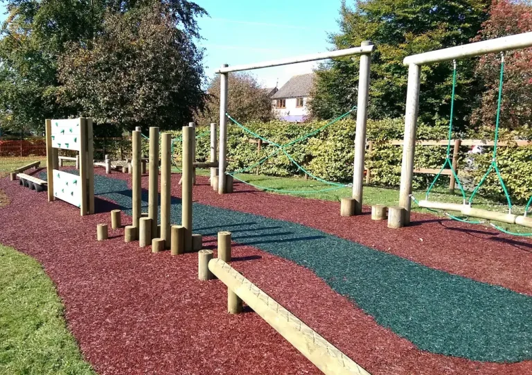 Tuscan Red & Forest Green JungleMulch pathways through trimtrails in a play area