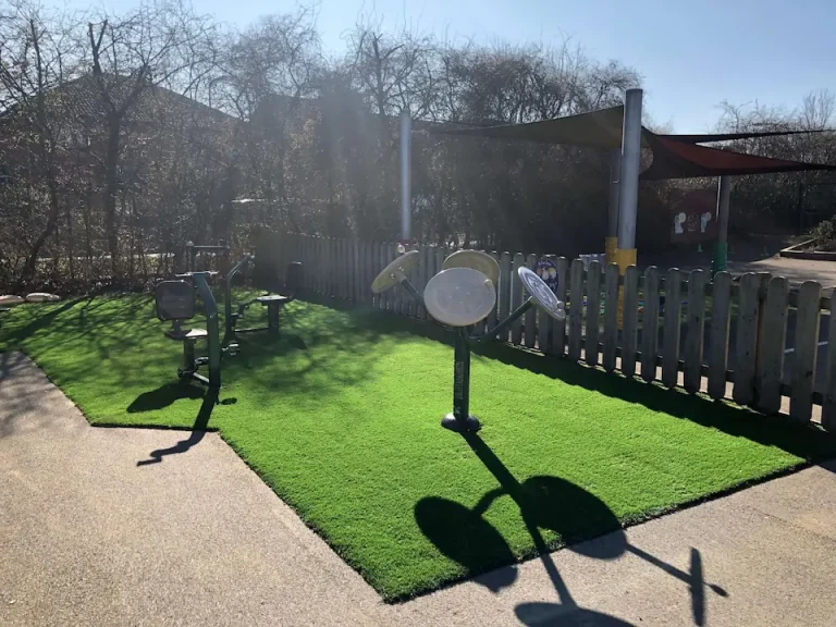 A small section of playground with ActiveGym equipment beside a sail shade