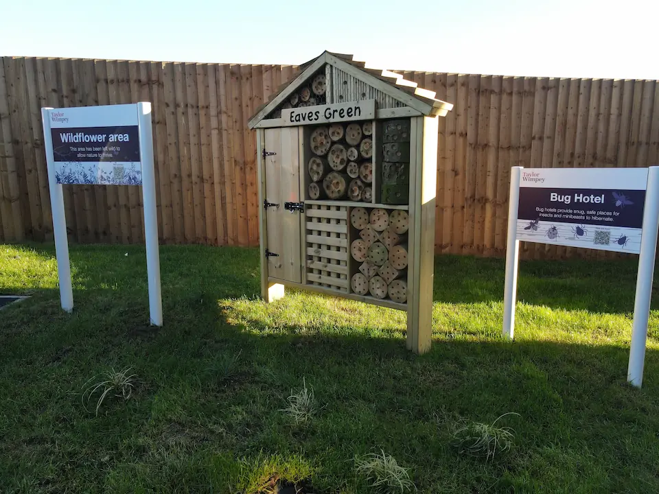 Green bug hotel with Wildflower Area and Bug Hotel signage