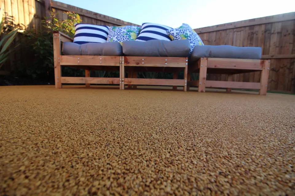 close-up of resin bound surfacing with wooden bench seating