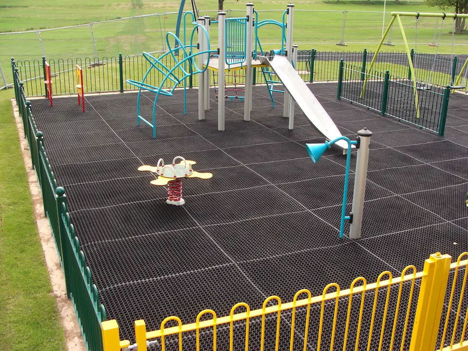 playground with rubber matting, slide, climbing frame and swings