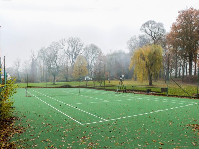 FlexCourt's modular sport surface installed in a large tennis court