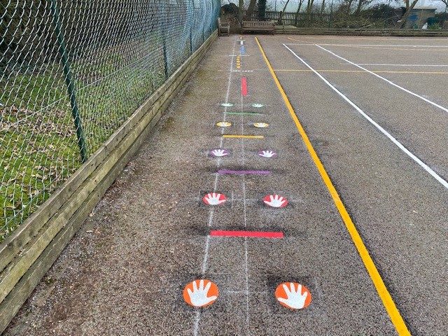 Colourful hand and line markings on a Daily Mile track