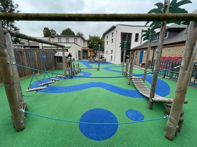 Blue and green wetpour safety surfacing installation