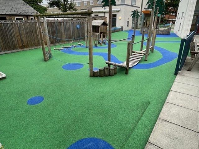 Blue and green wetpour safety surfacing installation