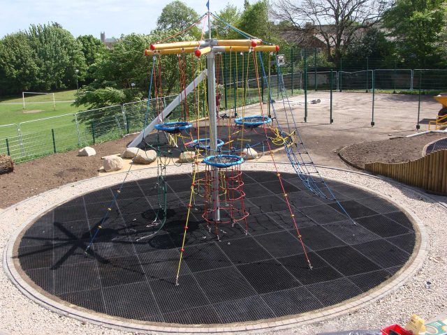 EcoSmart grass mat circle beneath climbing tower at Bristol Rowditch play area